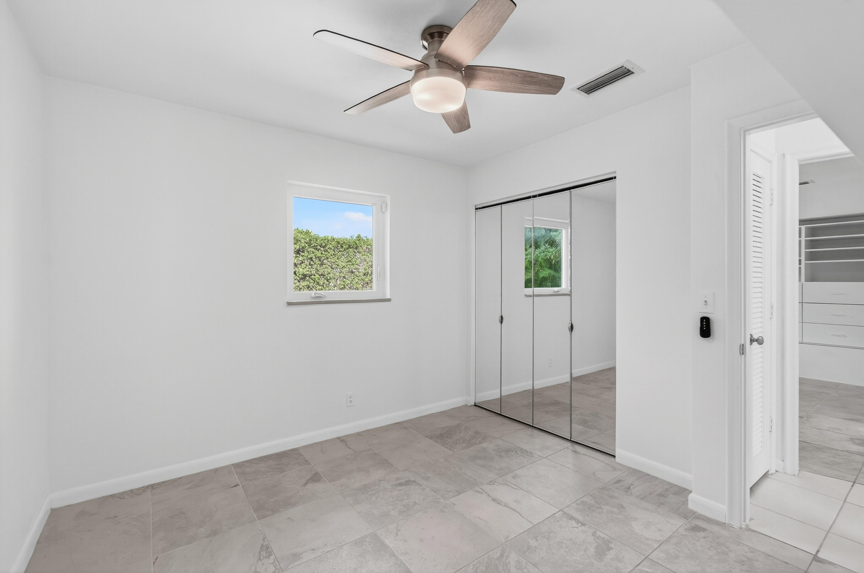 699 Northwest 16th Avenue Boca Raton, FL 33486 - Photo 18 of 32 a view of an empty room with a ceiling fan
