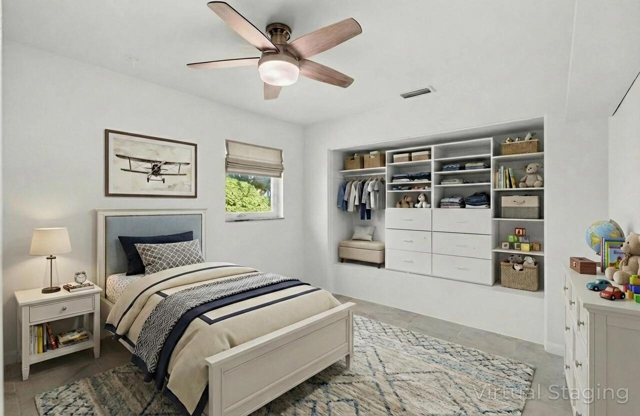 699 Northwest 16th Avenue Boca Raton, FL 33486 - Photo 20 of 39 a bedroom with a large bed and a window