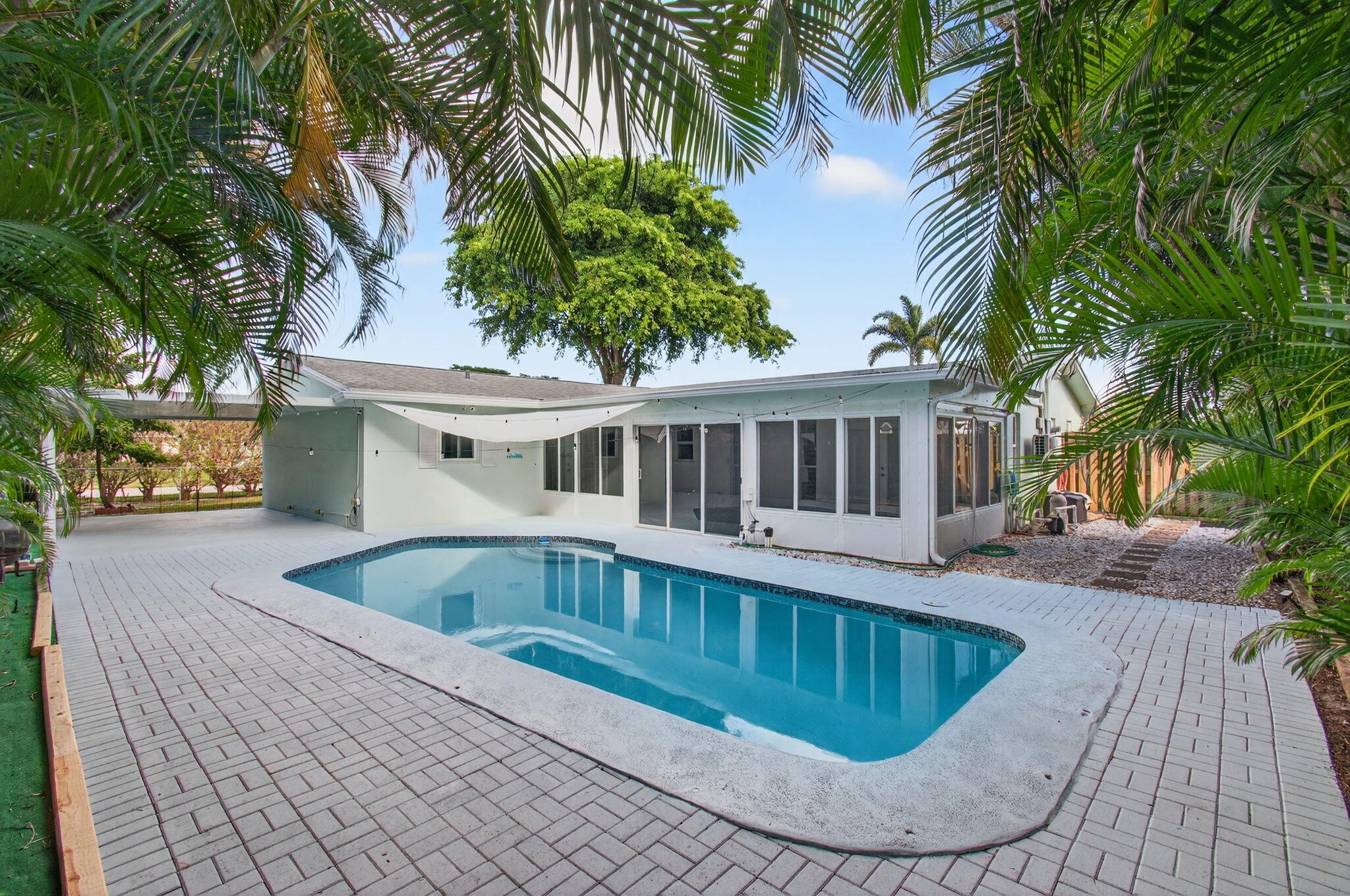 699 Northwest 16th Avenue Boca Raton, FL 33486 - Photo 2 of 32 a view of a house with swimming pool and sitting area