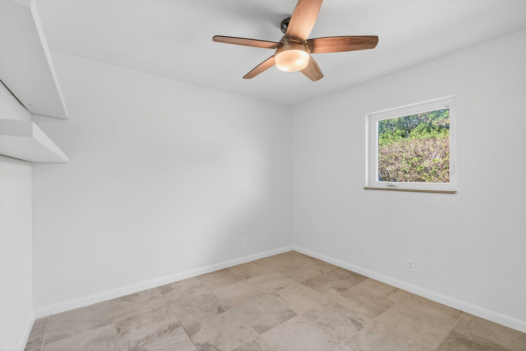 699 Northwest 16th Avenue Boca Raton, FL 33486 - Photo 21 of 39 an empty room with a fan and a window