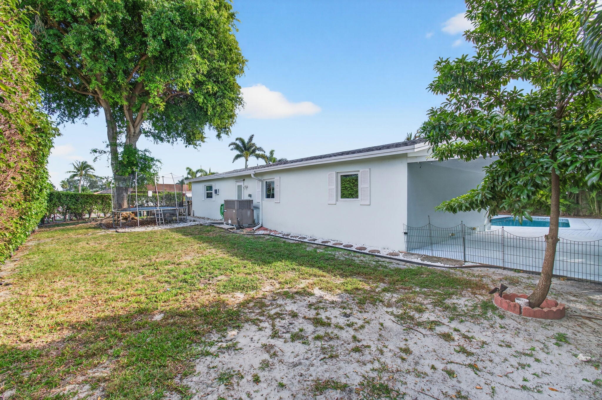 699 Northwest 16th Avenue Boca Raton, FL 33486 - Photo 36 of 39 a view of house with backyard and a tree