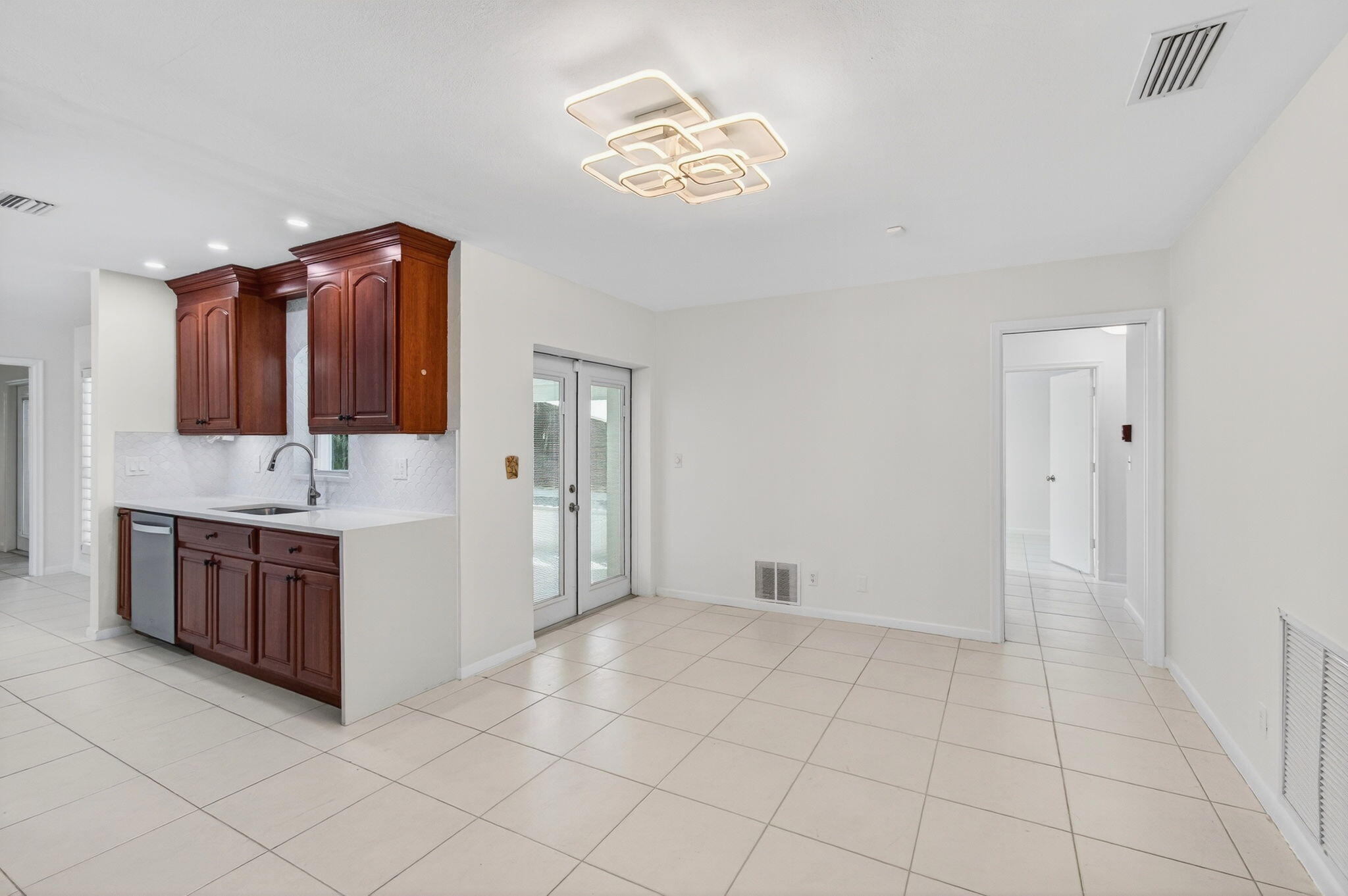 699 Northwest 16th Avenue Boca Raton, FL 33486 - Photo 7 of 32 a spacious bathroom with a granite countertop sink a mirror and a bathtub