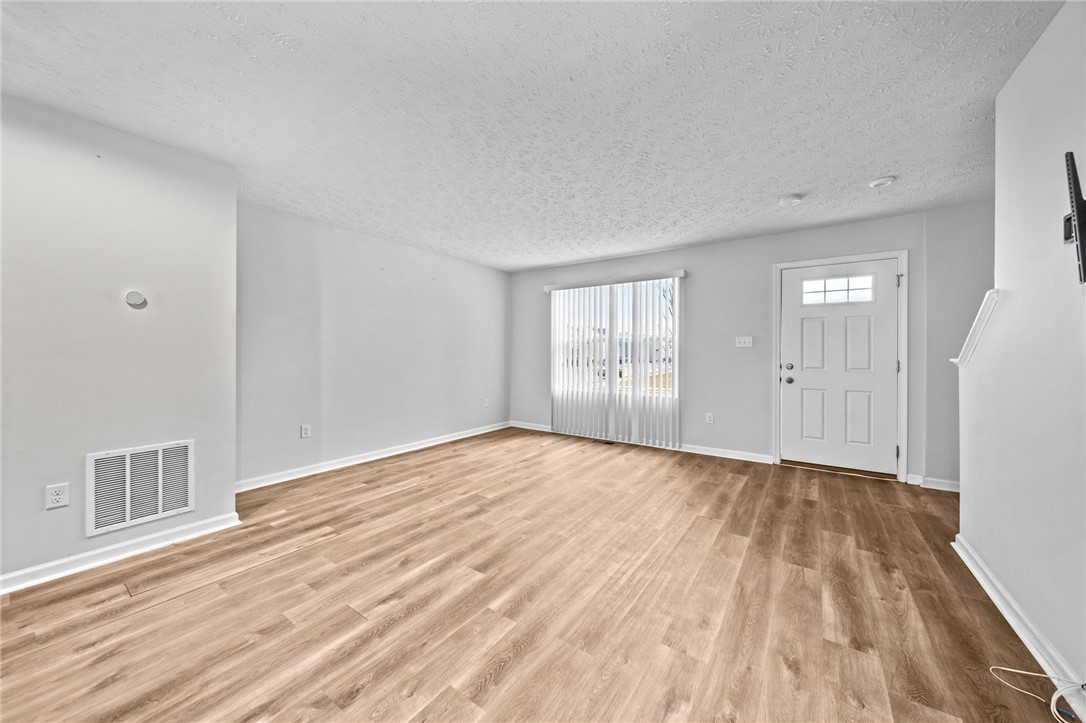 226 Golden Gate Avenue Springfield, OH 45506 - Photo 3 of 20 Bright and open, this living space features durable flooring and a welcoming entryway.