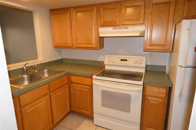a view of a kitchen with a sink and a cabinet