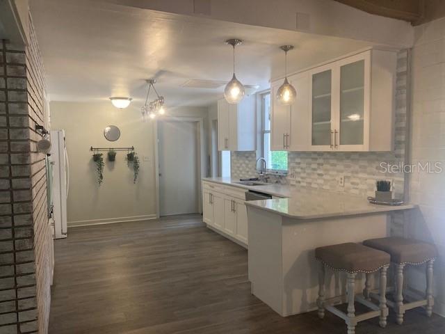 813 Northwest 22nd Street Gainesville, FL 32603 - Photo 11 of 32 a large kitchen with cabinets a sink a window and stainless steel appliances