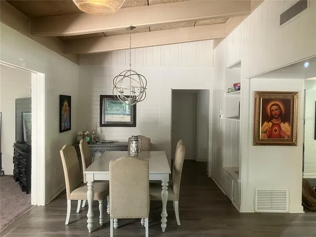 a view of a dining room with furniture wooden floor and chandelier