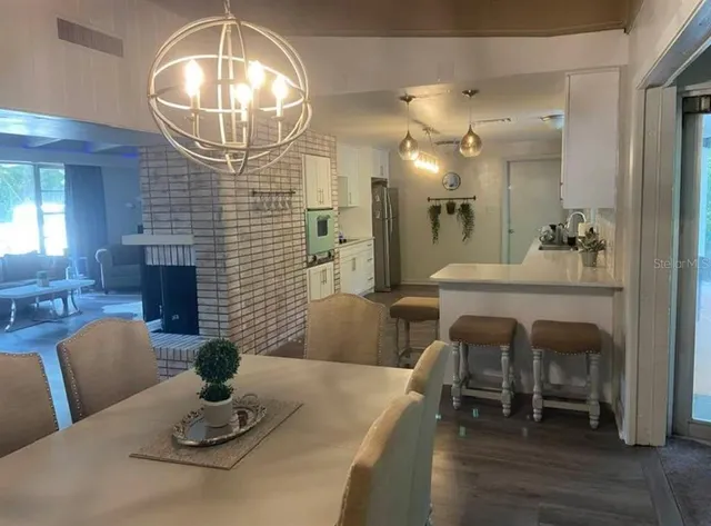 a dining room with furniture and a chandelier