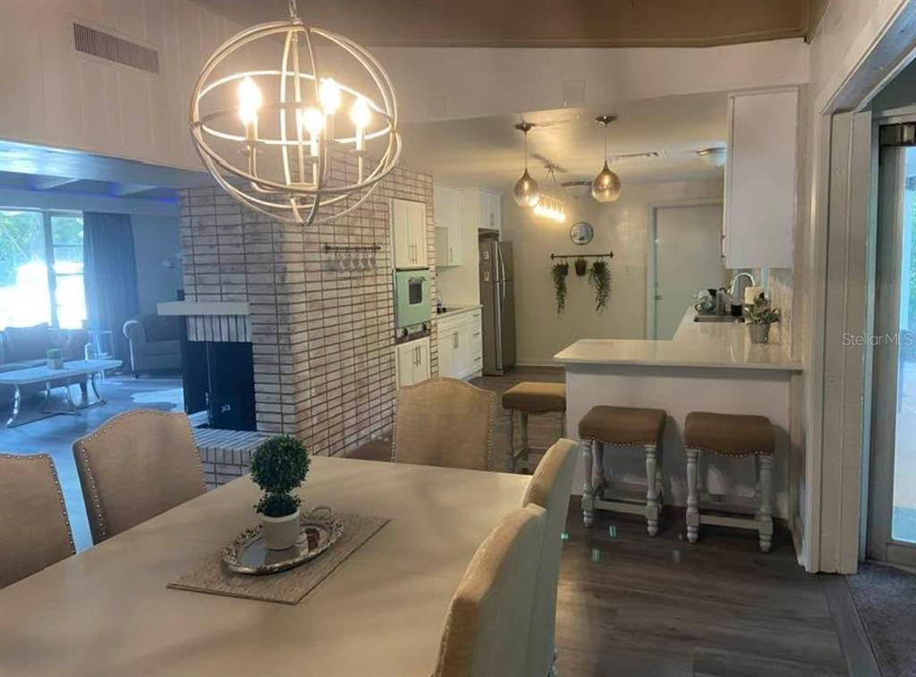 813 Northwest 22nd Street Gainesville, FL 32603 - Photo 15 of 32 a dining room with furniture and a chandelier