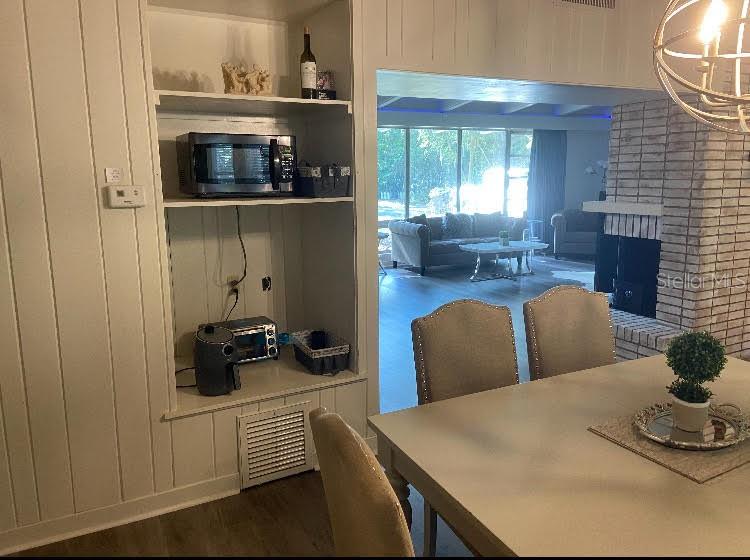 813 Northwest 22nd Street Gainesville, FL 32603 - Photo 16 of 32 a living room with furniture and a fireplace
