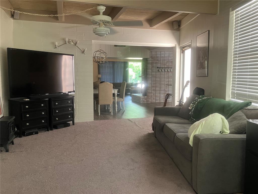 813 Northwest 22nd Street Gainesville, FL 32603 - Photo 18 of 32 a living room with furniture and a flat screen tv