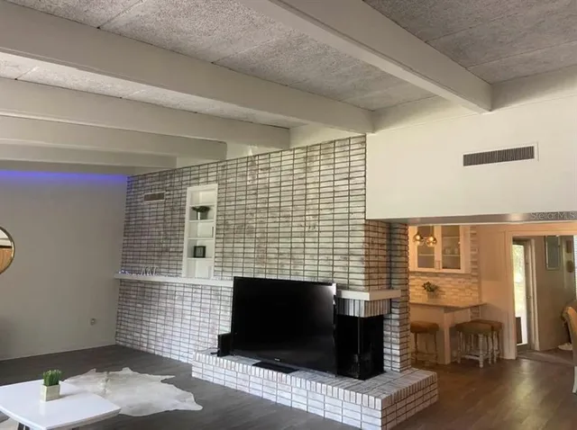 a living room with furniture wooden floor and a fireplace