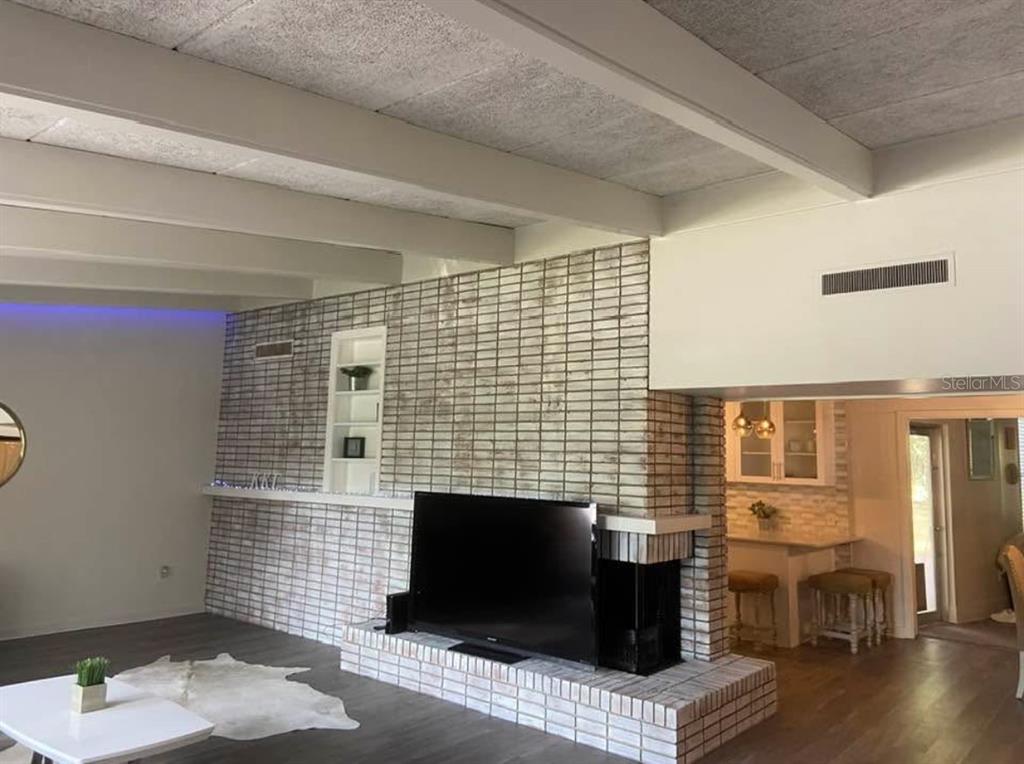 813 Northwest 22nd Street Gainesville, FL 32603 - Photo 8 of 32 a living room with furniture wooden floor and a fireplace