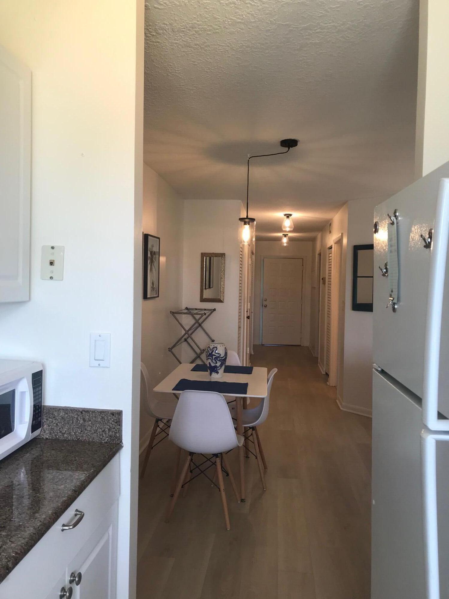 353 Highway 1, Unit D203 Jupiter, FL 33477 - Photo 2 of 13 a kitchen with stainless steel appliances granite countertop a sink and a refrigerator