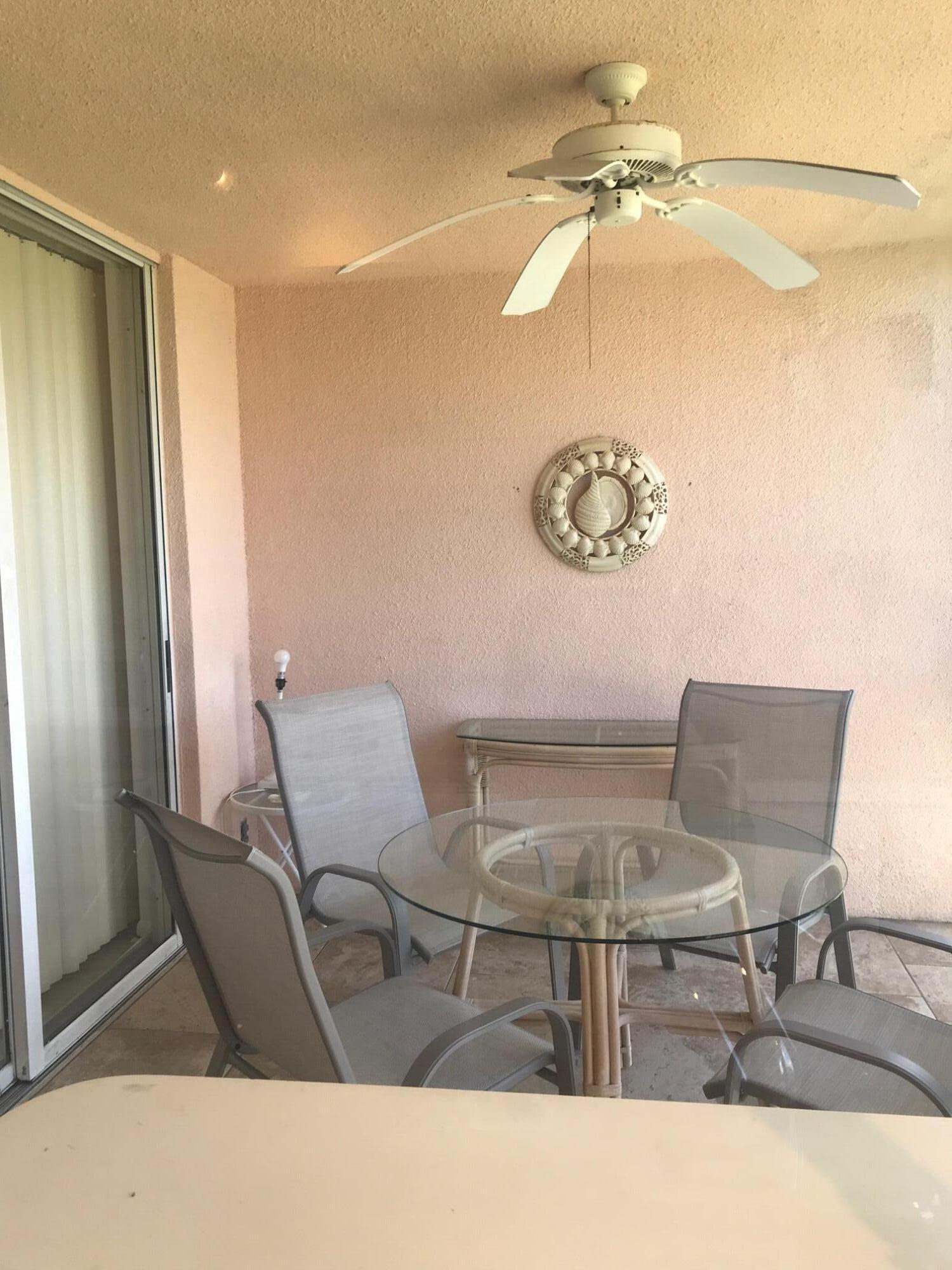 353 Highway 1, Unit D203 Jupiter, FL 33477 - Photo 3 of 13 a living room with a table and chairs