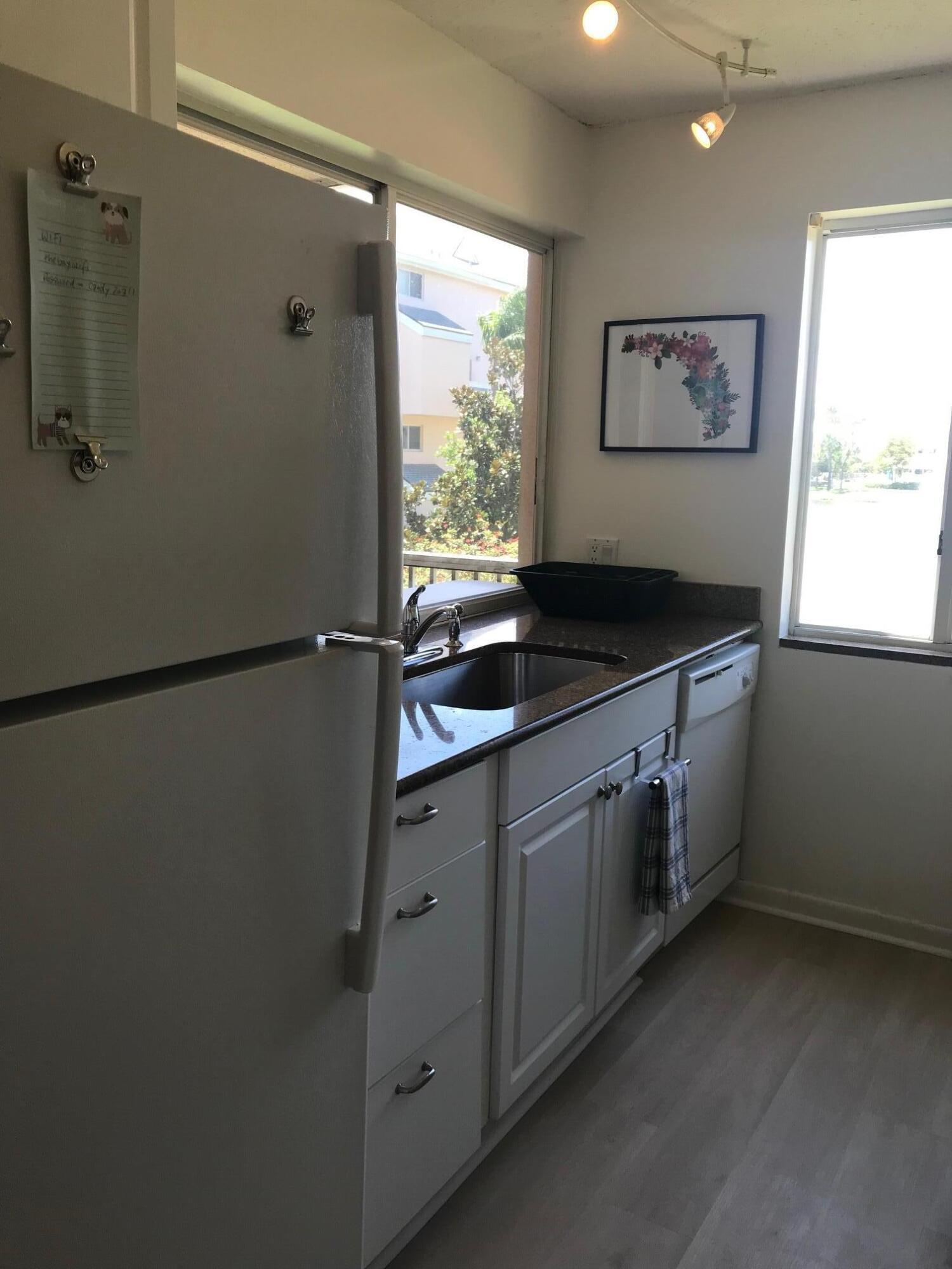 353 Highway 1, Unit D203 Jupiter, FL 33477 - Photo 4 of 13 a kitchen with a refrigerator and a sink