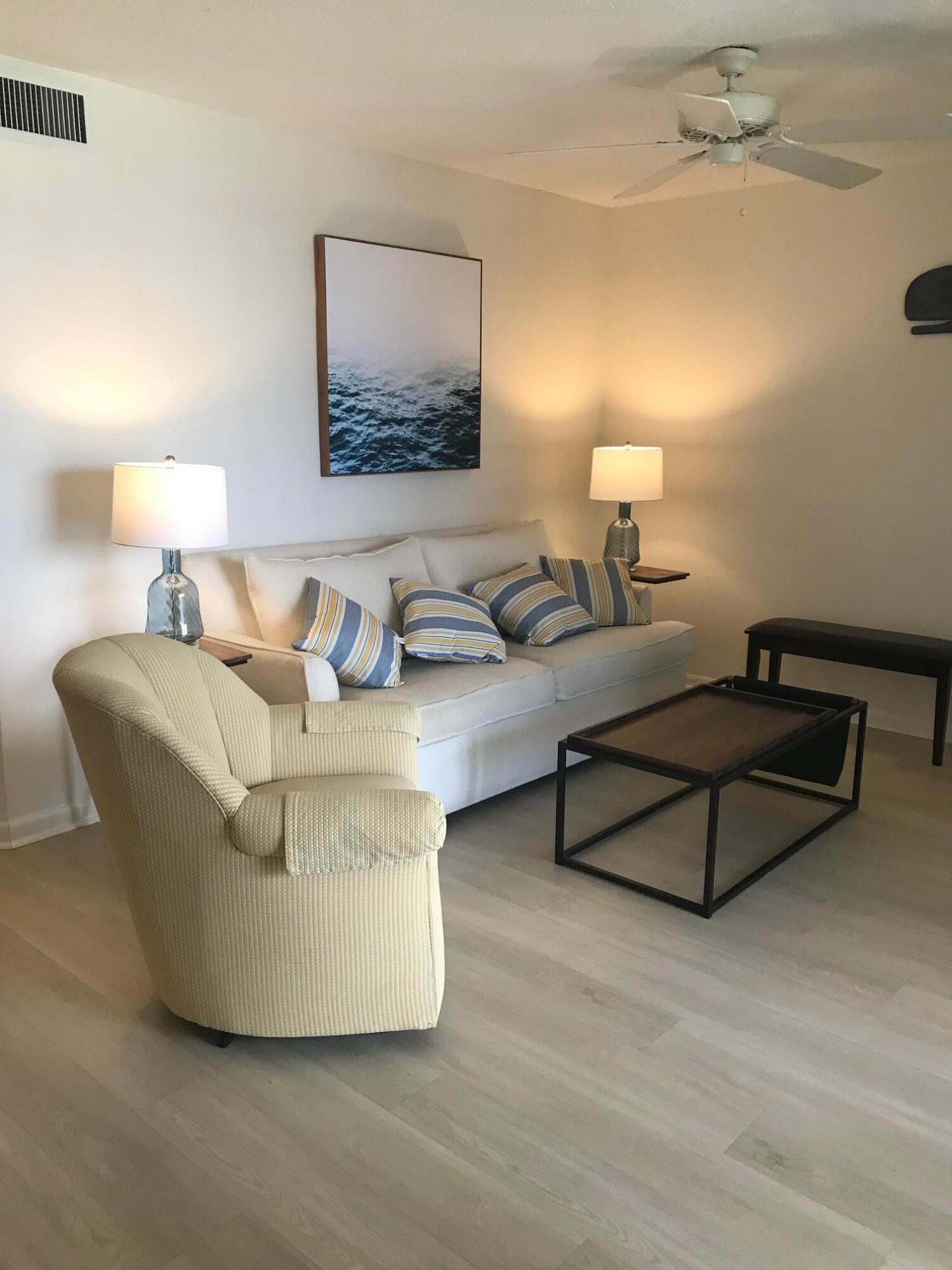 353 Highway 1, Unit D203 Jupiter, FL 33477 - Photo 9 of 13 a living room with furniture and a lamp