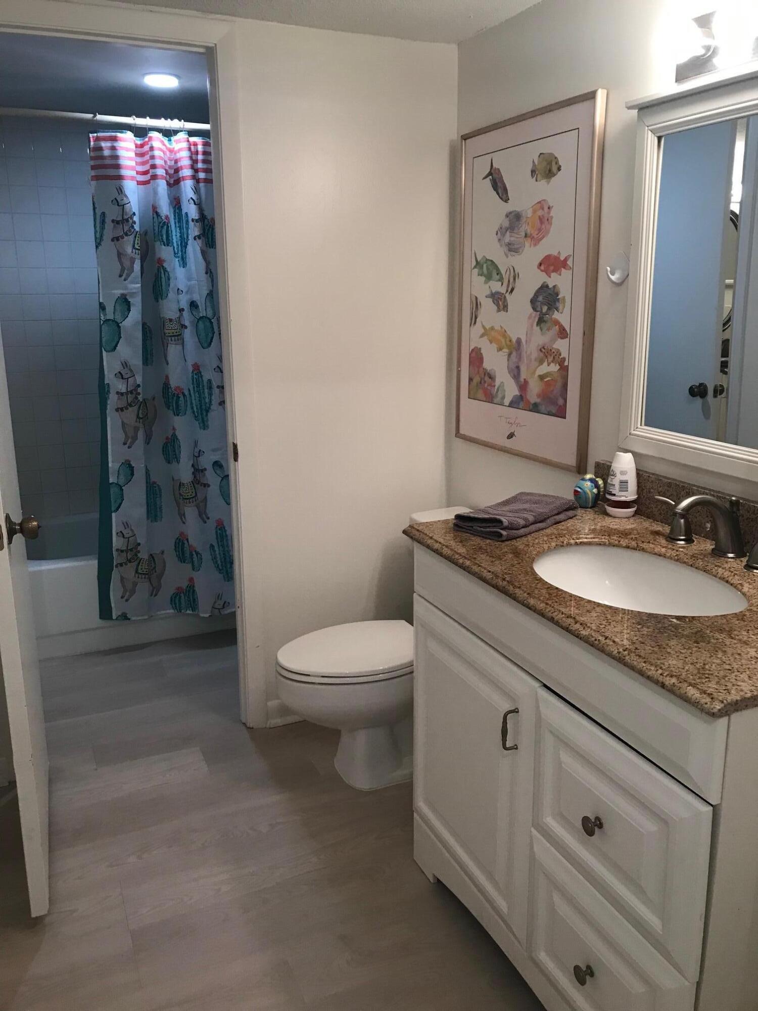 353 Highway 1, Unit D203 Jupiter, FL 33477 - Photo 10 of 13 a bathroom with a granite countertop sink toilet and shower