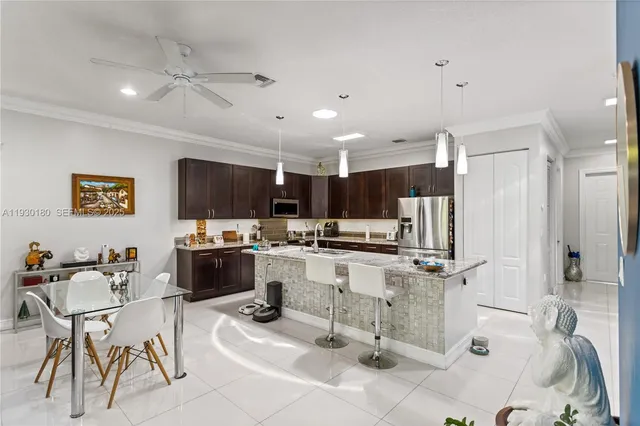 a kitchen with stainless steel appliances kitchen island granite countertop a sink and cabinets