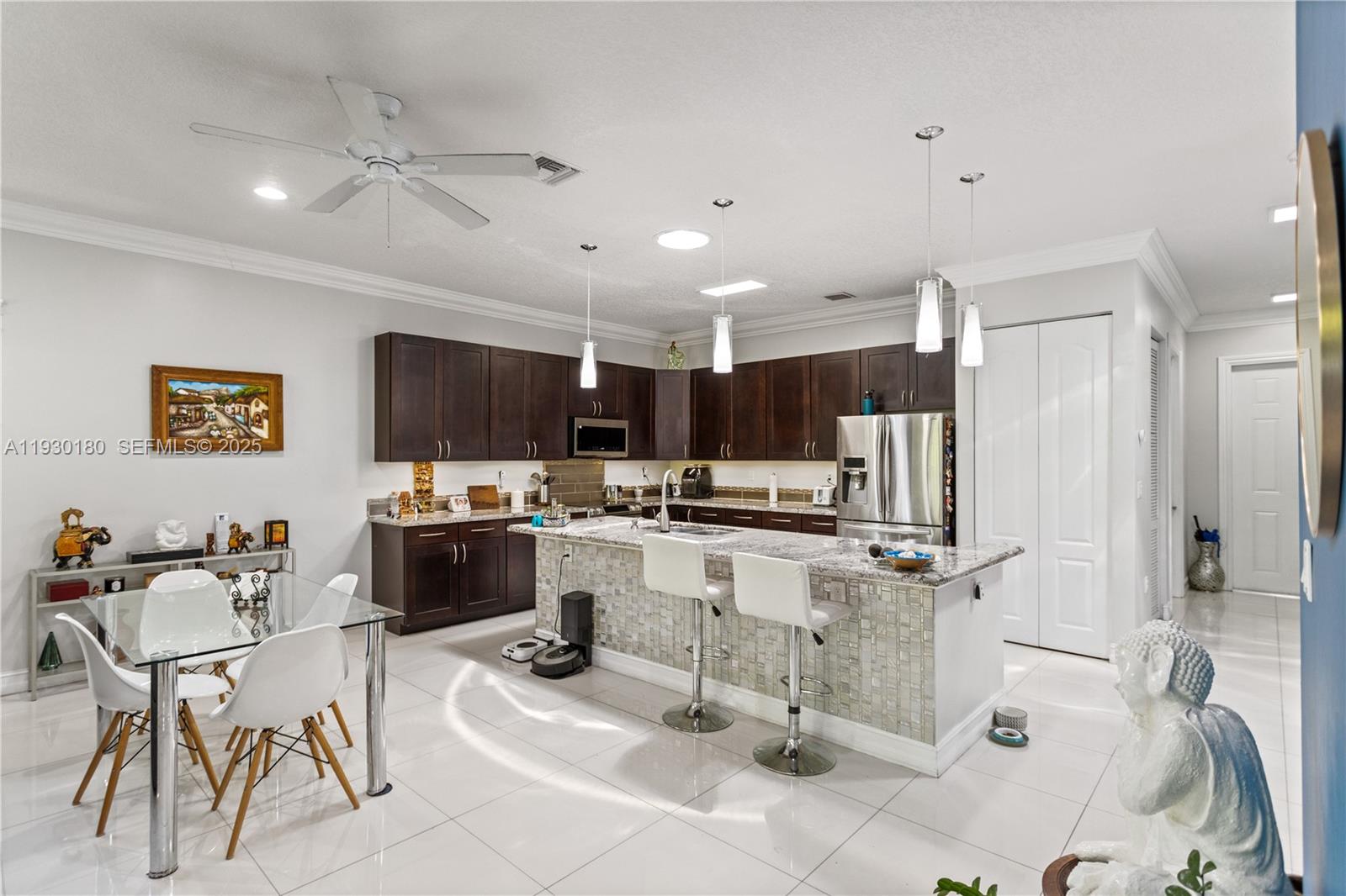 a kitchen with stainless steel appliances kitchen island granite countertop a sink and cabinets