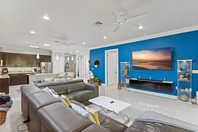 a living room with furniture and kitchen view