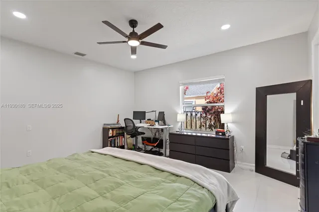 a bedroom with a bed a desk and chair