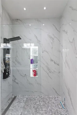 a bedroom with a large bed and a flat tv screen on a dresser