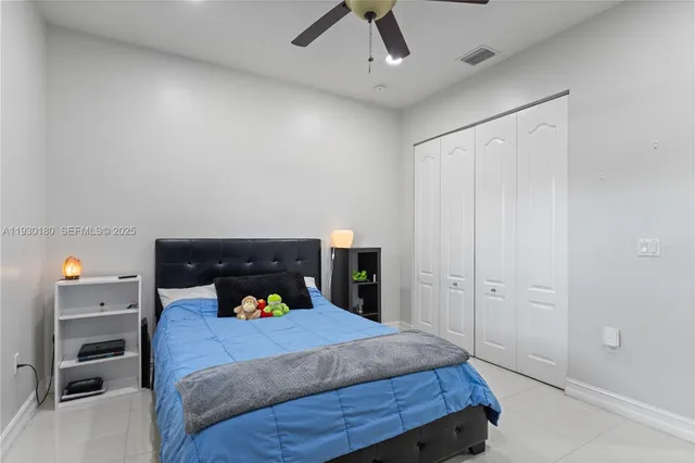 a bathroom with a granite countertop sink a toilet and a mirror