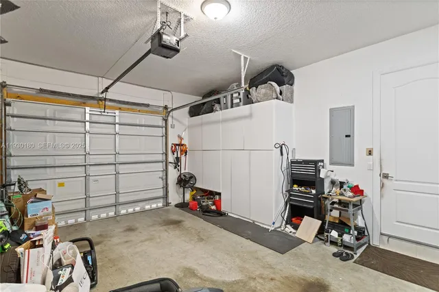 a living room with hardwood floor and a floor to ceiling window