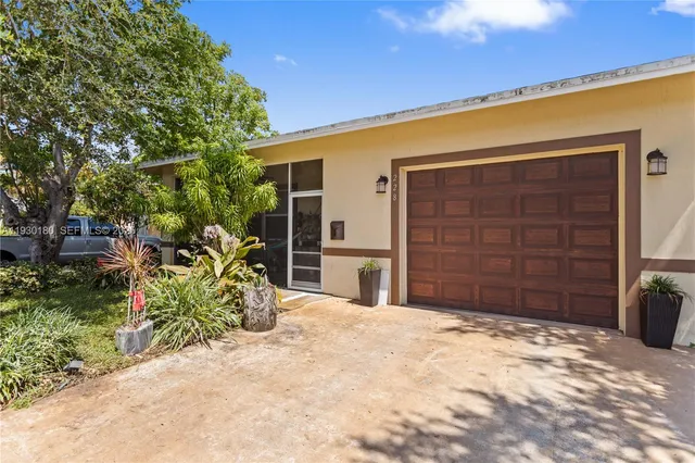 a sign that is sitting in front of flowers