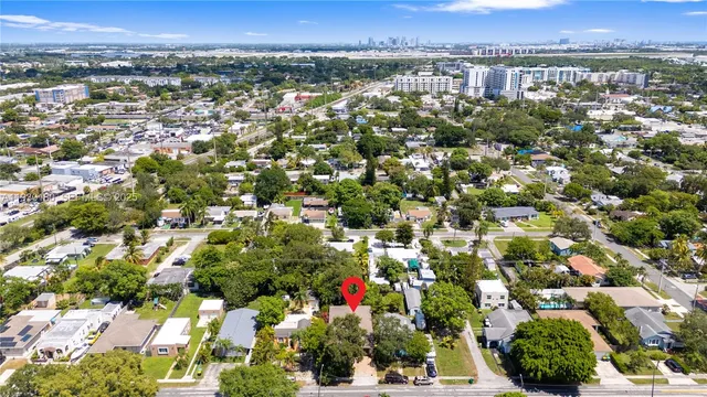 an aerial view of residential houses with city view