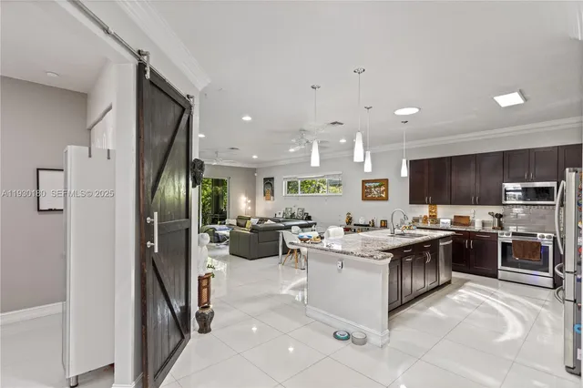 a kitchen with a sink a stove a refrigerator and a cabinets
