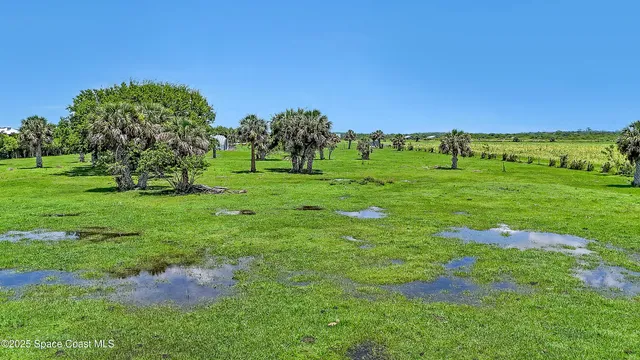 a view of a golf course with a building in the background