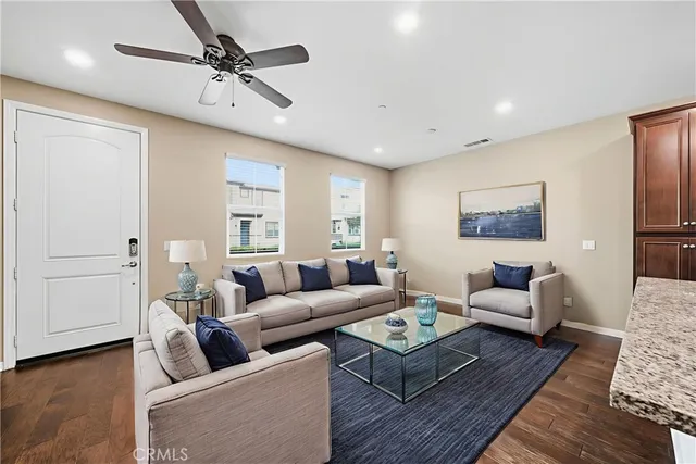 a living room with furniture and a wooden floor