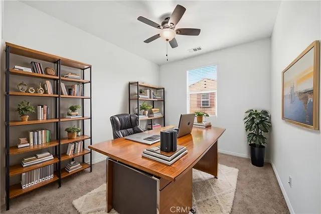 a dining room with furniture and a book shelf