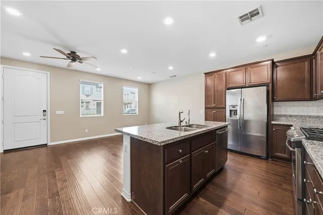 a kitchen with refrigerator cabinets and wooden floor