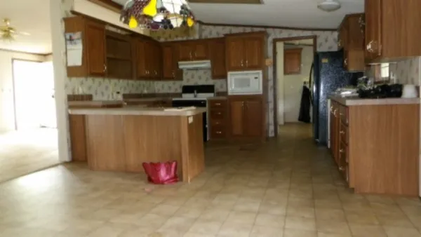 a kitchen with refrigerator and a stove