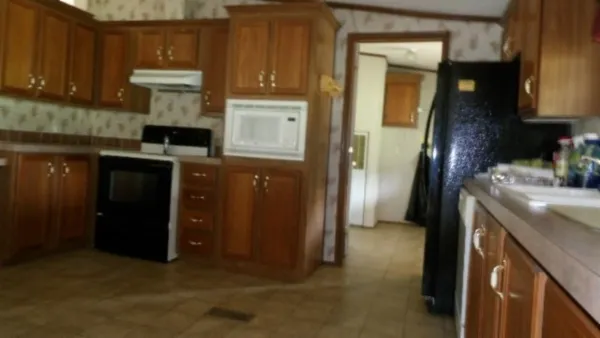 a kitchen with a refrigerator and a sink