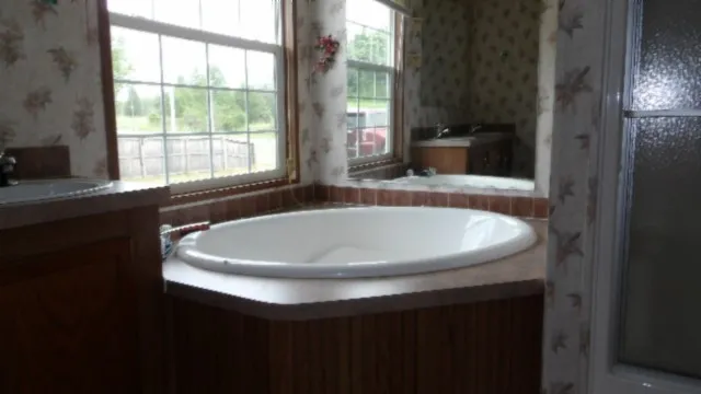 a bath tub sitting in a bathroom next to a window