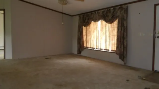 a kitchen with granite countertop a refrigerator stove and sink