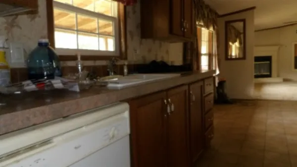 a kitchen with a sink and a mirror