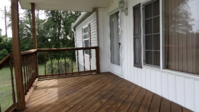 a view of balcony with floor to ceiling windows and wooden floor
