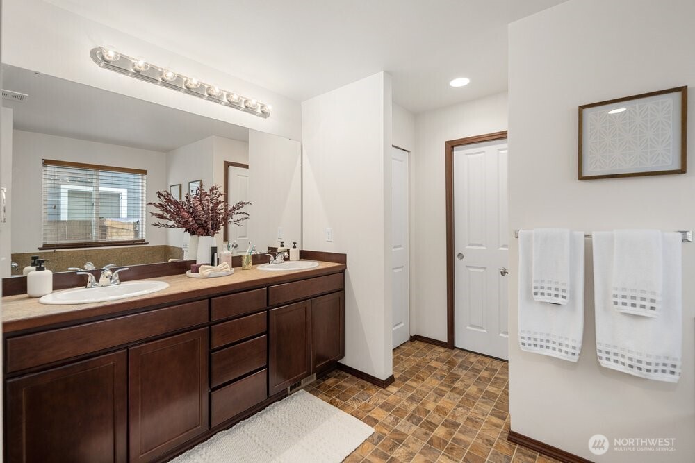 1152 Johnson Street Monroe, WA 98272 - Photo 11 of 38 a spacious bathroom with a double vanity sink a mirror and shower