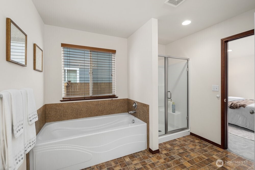 1152 Johnson Street Monroe, WA 98272 - Photo 13 of 38 a bathroom with a bathtub and a shower