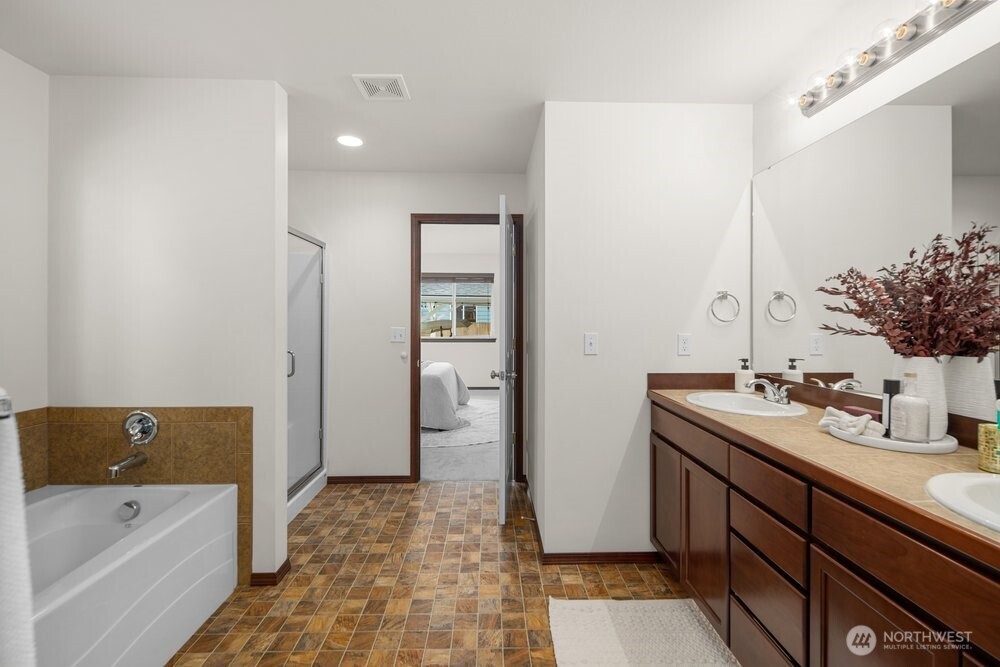 1152 Johnson Street Monroe, WA 98272 - Photo 14 of 38 a spacious bathroom with a tub sink and mirror