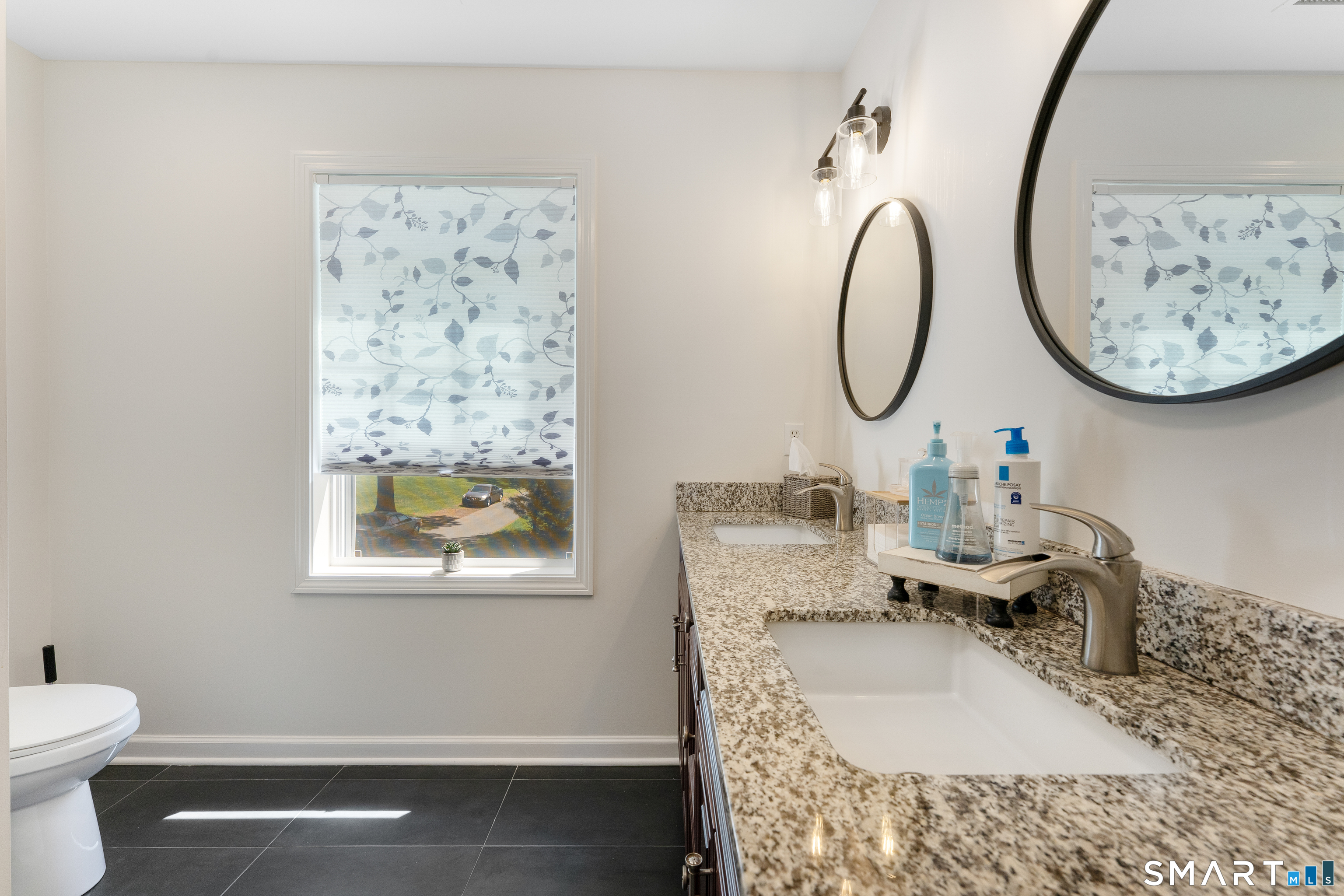 261 Spring Road North Haven, CT 06473 - Photo 28 of 39 a bathroom with a toilet sink and mirror