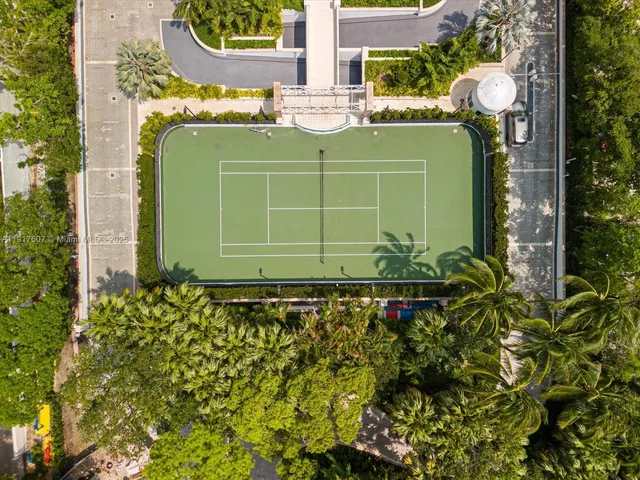 a green building with trees in front of it