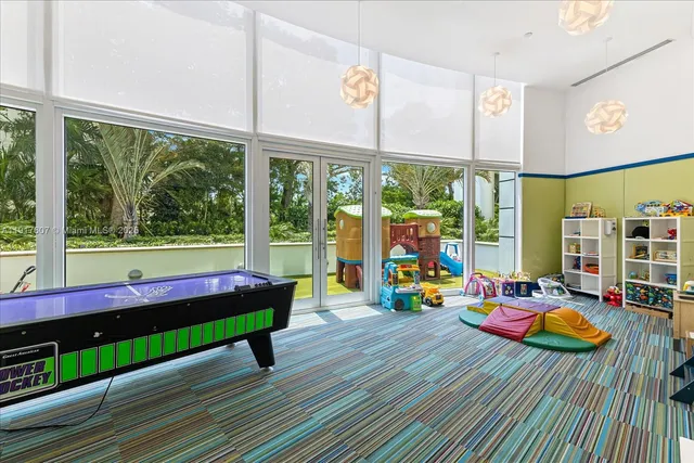 a room with musical instrument pool table and sofas