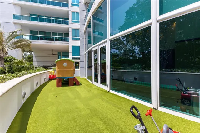 a swimming pool with lawn chairs next to yard