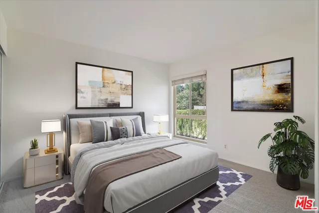 a bedroom with a bed and a painting on the wall