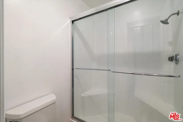a bathroom with a shower and a toilet